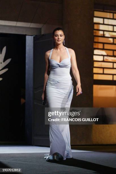 Italian actress Monica Bellucci arrives on stage during the opening ceremony of the 56th Cannes film festival 14 May 2003. French director Gerard...