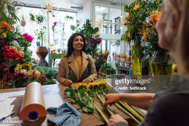 excited for her fresh sunflowers - communication occupation stock pictures, royalty-free photos & images