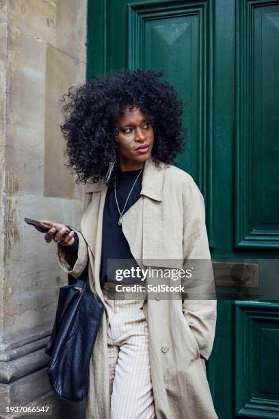 looking stylish for work - trenchcoat stockfoto's en -beelden