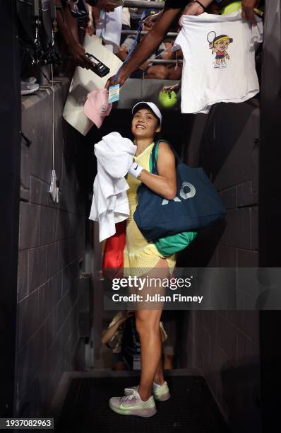 Emma Raducanu of Great Britain signs autographs after her win in their first round match against Shelby Rogers of the United States during the 2024...