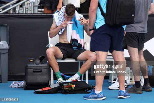 Jack Draper of Great Britain vomits after winning his round one singles match against Marcos Giron of the United States during the 2024 Australian...