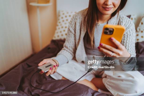 mujer navegando por las fotos del teléfono - copia de seguridad fotografías e imágenes de stock