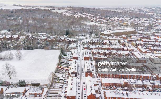 An aerial view of residential terraced houses following overnight snowfall on January 16, 2024 in Stalybridge, United Kingdom. The UK is in the grip...