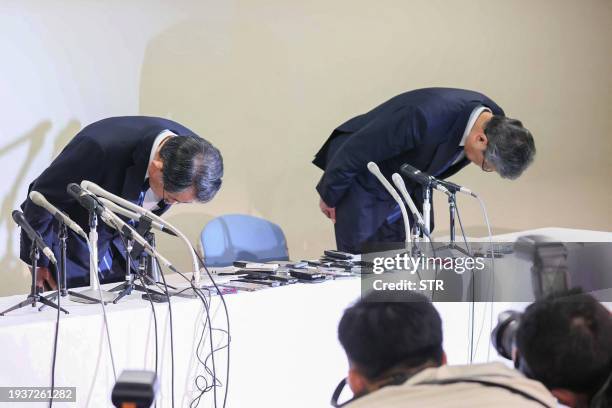 Liberal Democratic Party members Tsuyoshi Takagi , secretary general of the Abe faction, and Ryu Shionoya , a senior Abe faction official, bow at the...