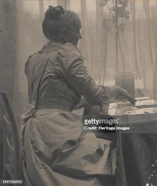 Woman Playing Solitaire, circa 1910. Self-portrait. Creator: Gertrude Kasebier.