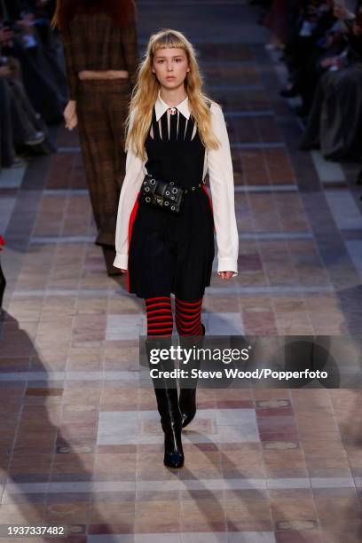 Model walks the runway at the Sonia Rykiel show during Paris Fashion Week Autumn/Winter 2016/17, she wears a black pinafore dress with cut out yoke...