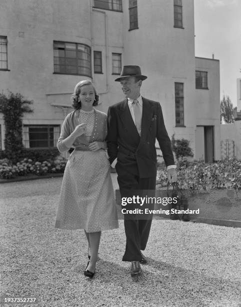 American actor and dancer Fred Astaire and daughter Ava, August 8th 1956. Astaire is carrying binoculars.