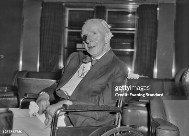 British architect George Grey Wornum seated in a wheelchair and wearing a tinted monocle, July 25th 1956.