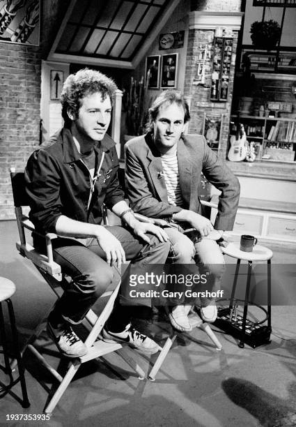 View of American Pop musicians Tommy Heath and Jim Keller, both of the band Tommy Tutone, as they sit in director's chairs during an interview on MTV...