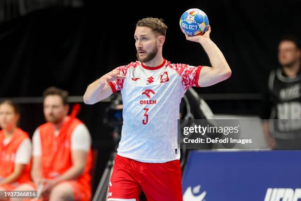 Michal Daszek of Poland controls the ball during the Men's EHF Euro 2024 preliminary round match between Poland and Faroe Islands at Mercedes-Benz...