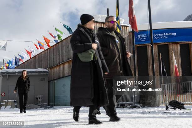 January 2024, Switzerland, Davos: People walk in front of the World Economic Forum Convention Center. The annual meeting of the World Economic Forum...