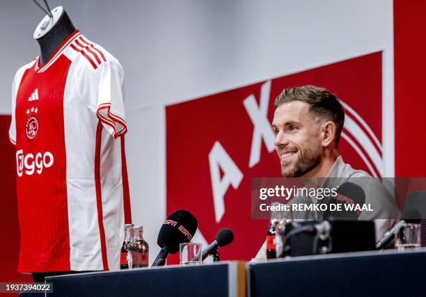 Ajax's newly recruited player, British midfielder Jordan Henderson gives a press conference during his official presentation at the ArenA in...