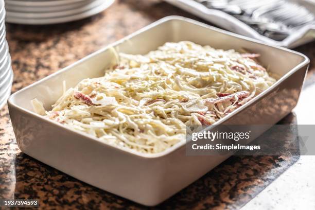 coleslaw salad in a white bowl on a restaurant buffet table. - coleslaw stock pictures, royalty-free photos & images