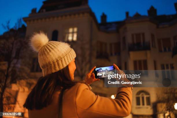new beginnings: capturing future home possibilities - woman capturing city night stockfoto's en -beelden