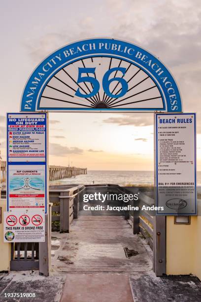 beach access 56 to panama city beach public beach park with many information signs, florida, usa - panama city beach imagens e fotografias de stock