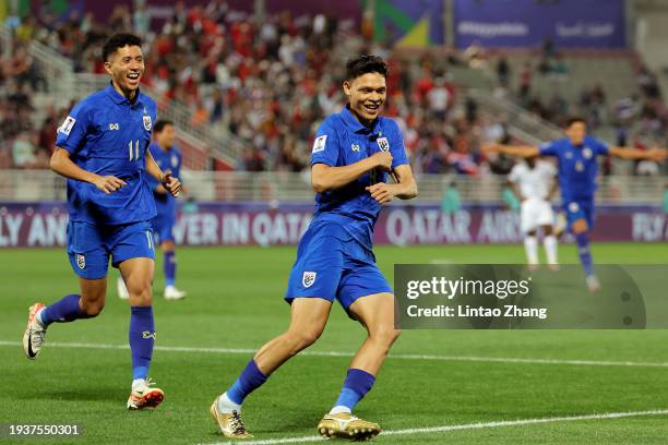 Supachai Chaided of Thailand celebrates scoring their second goal with Bordin Phala during the AFC Asian Cup Group F match between Thailand and...