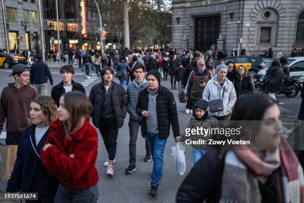 People stroll through the Portal del Angel, one of the most commercial streets in the city center on January 13, 2024 in Barcelona, Spain.