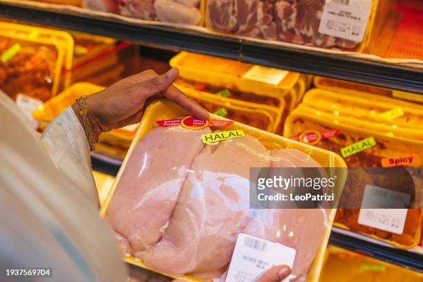 woman buying halal meat in a supermarket - halal stock pictures, royalty-free photos & images