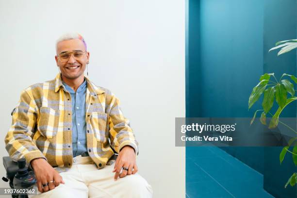 portrait of mixed race man with street style sit on wheelchair at white background - hair colour stock pictures, royalty-free photos & images