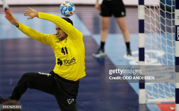 Portugal's goalkeeper Gustavo Capdeville jumps for the ball during the Men's EURO 2024 EHF Handball European Championship main round match between...