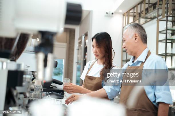 mentorship in the coffee business: senior owner and daughter at the bar counters - reopening ceremony stock pictures, royalty-free photos & images