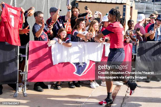 Houston Texans quarterback C.J. Stroud high fives fans as he jogs to the practice field during an NFL training camp Friday, July 28 in Houston.