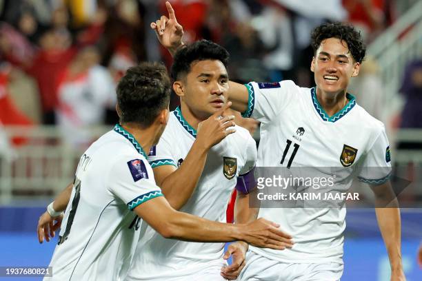 Indonesia's defender Asnawi Mangkualam celebrates after scoring his team's first goal from the penalty spot during the Qatar 2023 AFC Asian Cup Group...