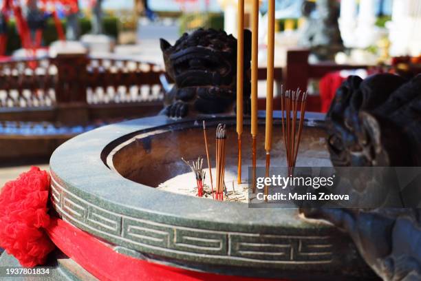 a bowl with figures of fu dogs for incense sticks in a chinese temple - chinese worship the god of fortune in guiyuan buddhist temple stockfoto's en -beelden