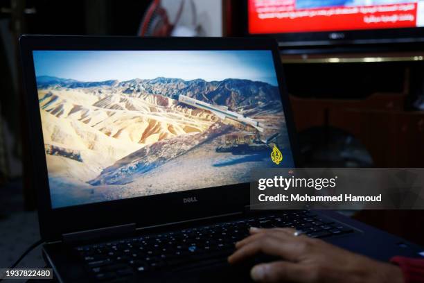 Yemeni man browsing the news on his laptop screen that broadcasts news relating to the attack on the Zografia ship in the Red Sea, on January 16 at...