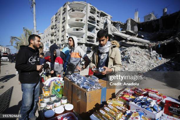 Palestinians shop at the market established between the destroyed buildings in the Israeli attacks at Nuseirat refugee camp in Deir al-Balah, Gaza on...
