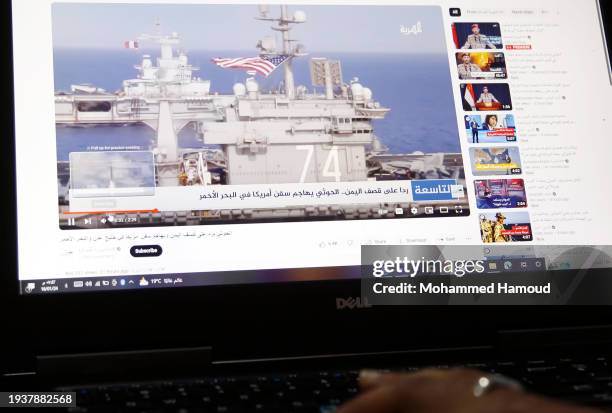 Yemeni man browsing the news on his laptop screen that broadcasts U.S.-U.K. Warships amid news spread relating to the attack on the Zografia ship in...