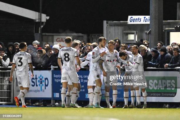 Aaron Wildig of Newport County celebrates scoring his team's first goal with teammates during the Emirates FA Cup Third Round Replay match between...