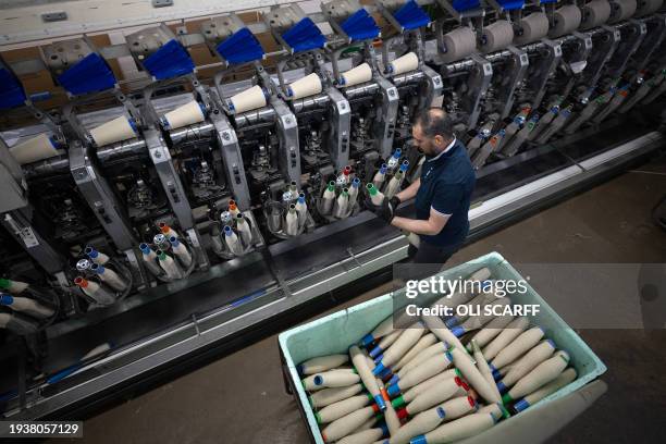 An employee at Mallalieus' mill works in their spinning room, in Delph, near Oldham, northern England on January 17, 2024. Founded in 1863,...