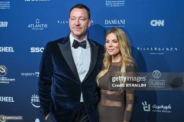 Former footballer John Terry and his wife Toni Terry pose for a picture as they arrive to attend the 14th edition of the Globe Soccer Awards in the...