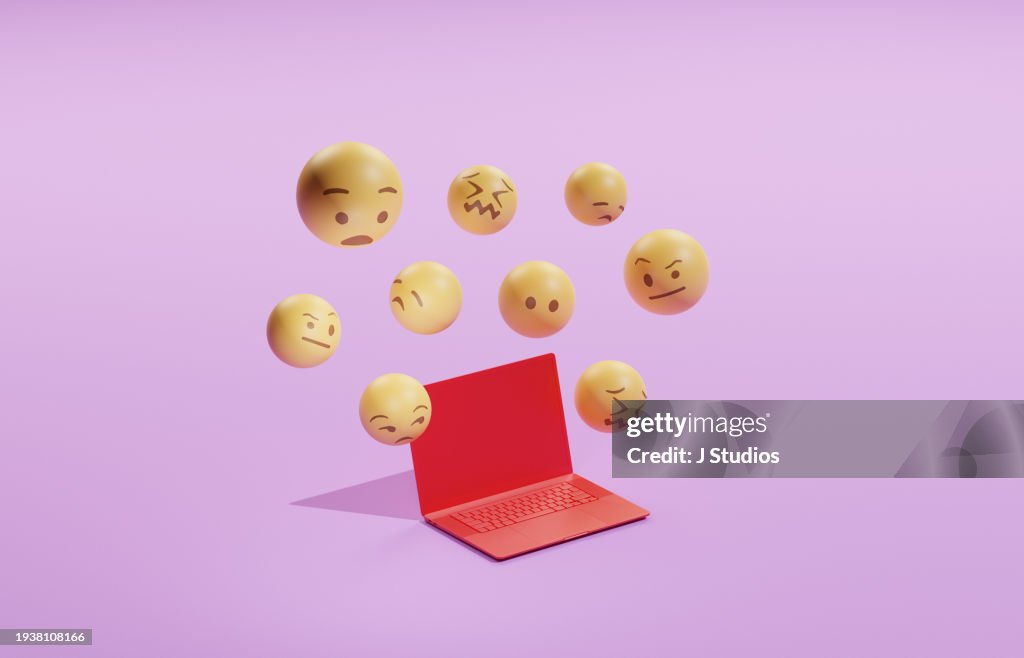 Emojis hovering over a laptop