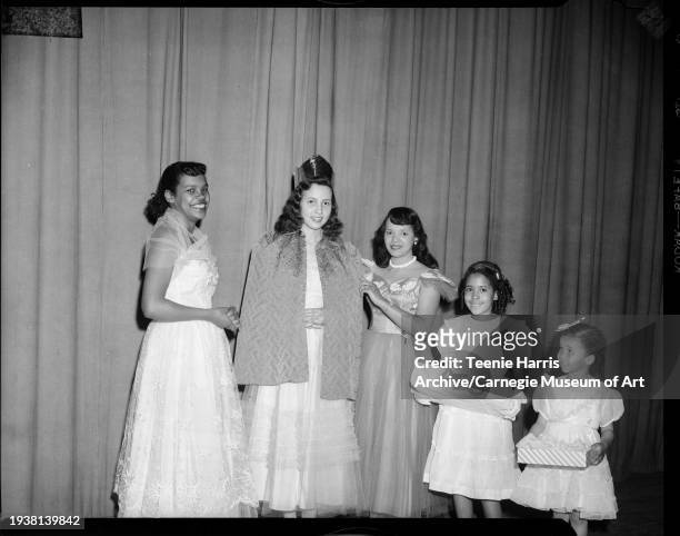 Three young women, including Charmaine Jeffries , and two girls pose on stage for the Delta Sigma Theta Sorority's 'Coronation Capers Jabberwock,'...