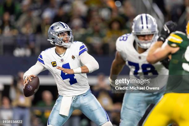 Dak Prescott of the Dallas Cowboys looks to pass during an NFL wild-card playoff football game between the Dallas Cowboys and the Green Bay Packers...