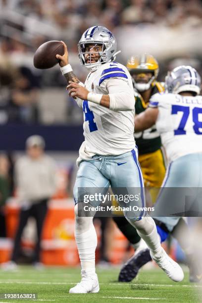 Dak Prescott of the Dallas Cowboys looks to pass on the run during an NFL wild-card playoff football game between the Dallas Cowboys and the Green...