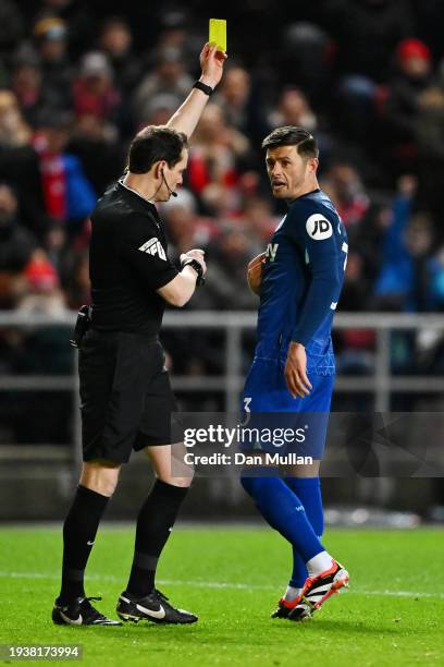 Aaron Cresswell of West Ham United receives a yellow card from referee Darren England during the Emirates FA Cup Third Round Replay match between...