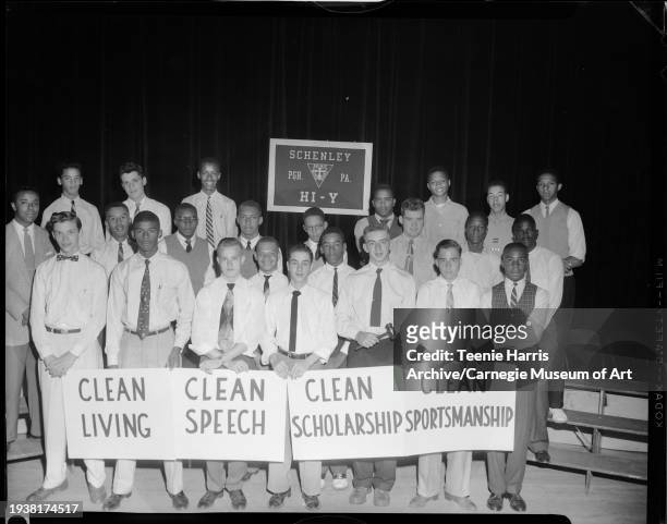 Group portrait of Schenley High School Hi-Y Club holding signs for clean living, Pittsburgh, Pennsylvania, 1955. First row left to right: James...