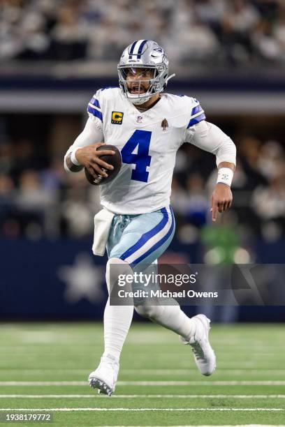 Dak Prescott of the Dallas Cowboys scrambles and runs with the ball during an NFL wild-card playoff football game between the Dallas Cowboys and the...