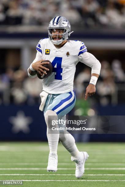 Dak Prescott of the Dallas Cowboys scrambles and runs with the ball during an NFL wild-card playoff football game between the Dallas Cowboys and the...