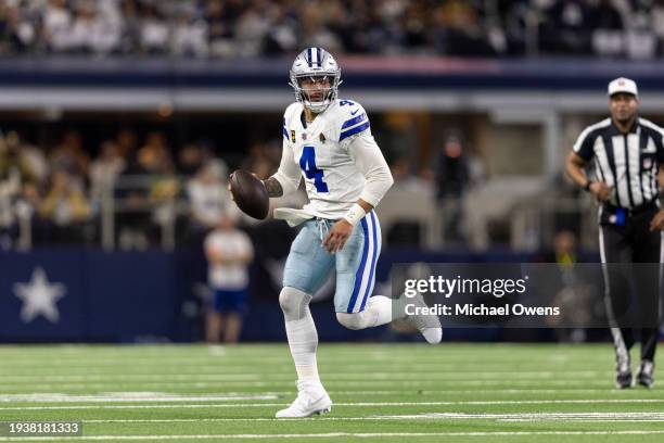 Dak Prescott of the Dallas Cowboys scrambles and runs with the ball during an NFL wild-card playoff football game between the Dallas Cowboys and the...