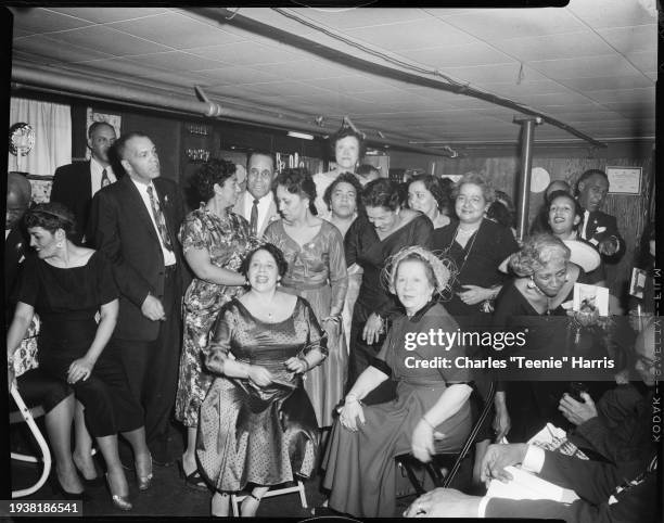 Group at Pittsburgh Girl Friends Christmas party in McNeills Catering, Adelaide Street, Pittsburgh, Pennsylvania, December 1955. Seated from left:...