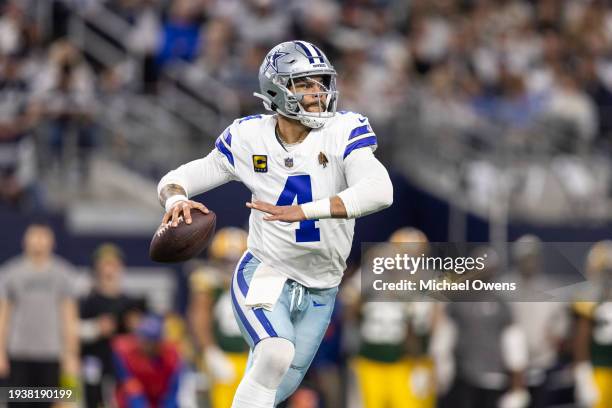 Dak Prescott of the Dallas Cowboys looks to pass on the run during an NFL wild-card playoff football game between the Dallas Cowboys and the Green...