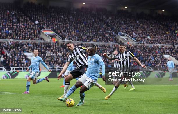 Jeremy Doku of Manchester City turns from Fabian Schar of Newcastle United during the Premier League match between Newcastle United and Manchester...
