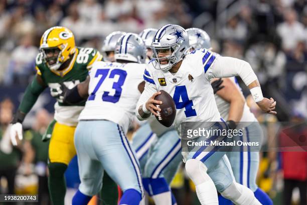 Dak Prescott of the Dallas Cowboys scrambles and runs with the ball during an NFL wild-card playoff football game between the Dallas Cowboys and the...