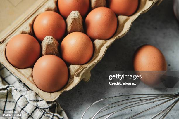 close-up of organic chicken eggs in carton over table in the kitchen - protein pancakes stock pictures, royalty-free photos & images
