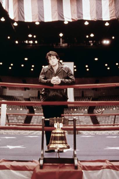 Promotional portrait of American actor Sylvester Stallone, as Rocky Balboa, standing in a boxing ring from the film "Rocky," directed by John G....