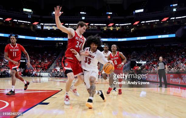 Skyy Clark of the Louisville Cardinals dribbles the ball while defended by Ben Middlebrooks the NC State Wolfpack in the second half of the 89-83 win...
